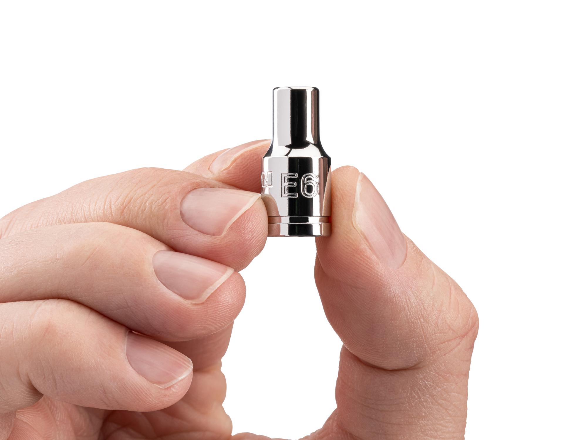 Person holding Tekton hand drive external star socket. Item #SHD02406