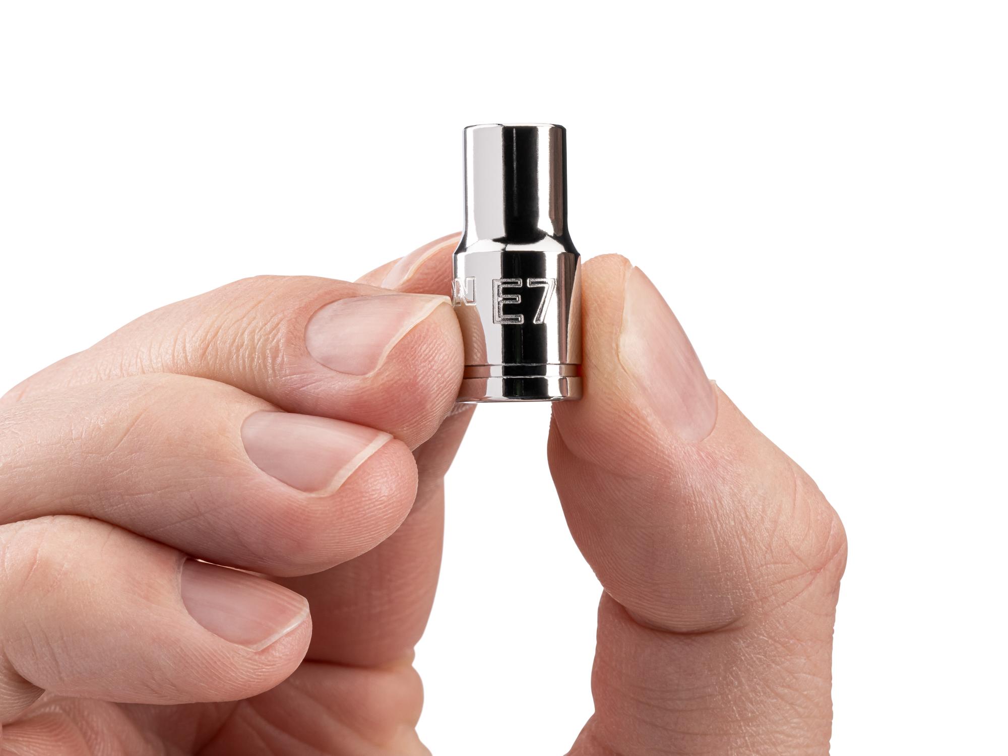 Person holding Tekton hand drive external star socket. Item #SHD02407