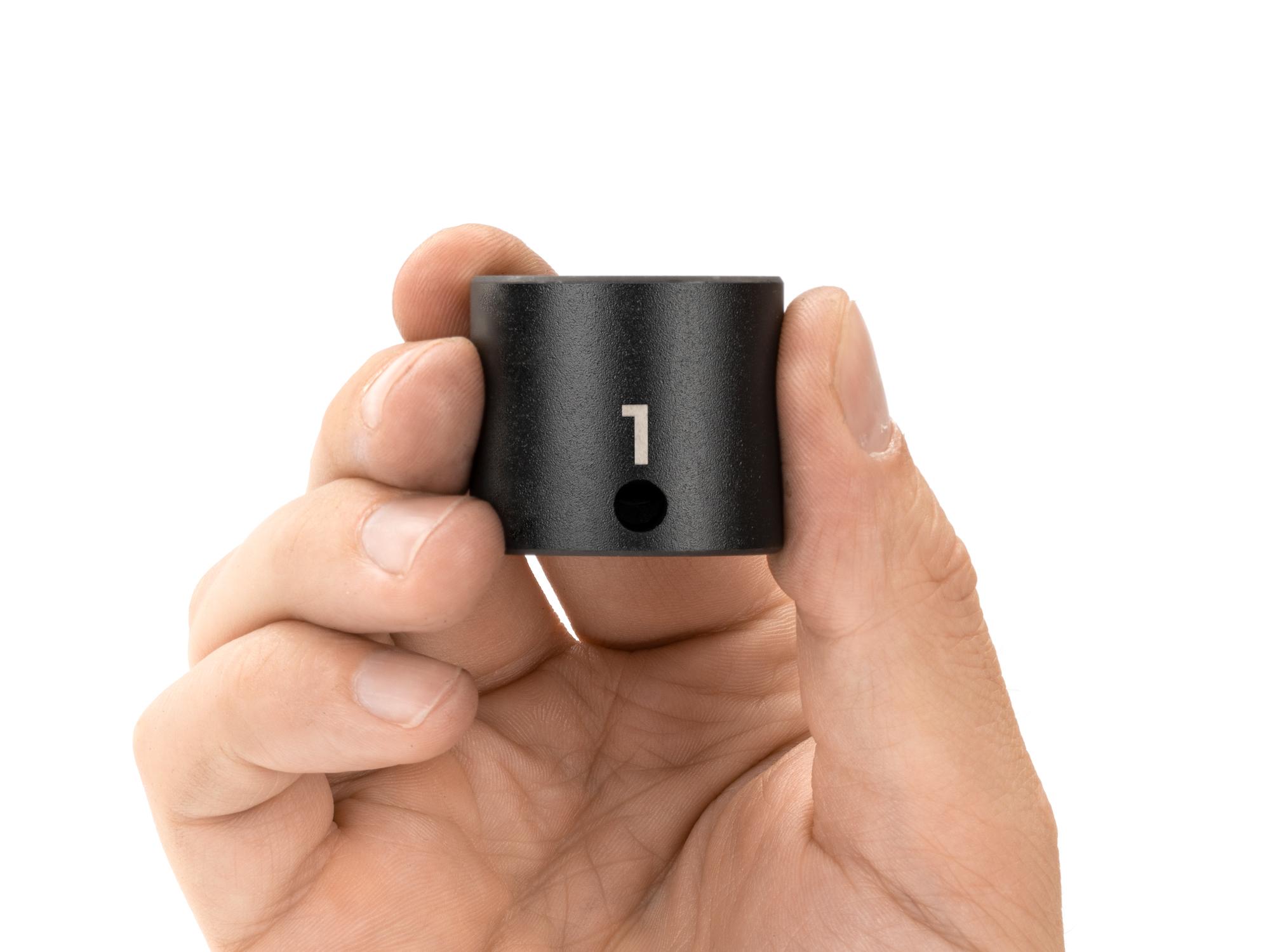 Person holding Tekton impact drive 12-point socket. Item #SID12225