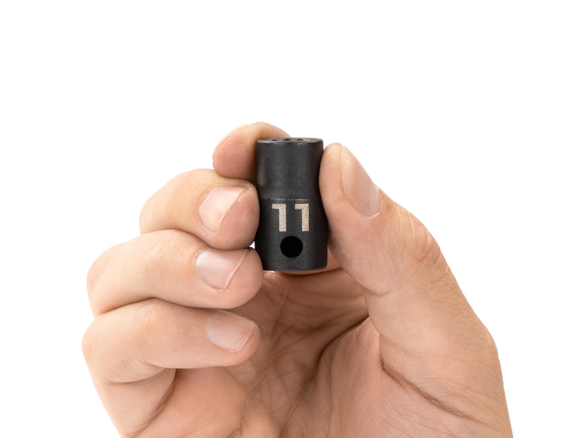 Person holding Tekton impact drive 12-point socket. Item #SID12311