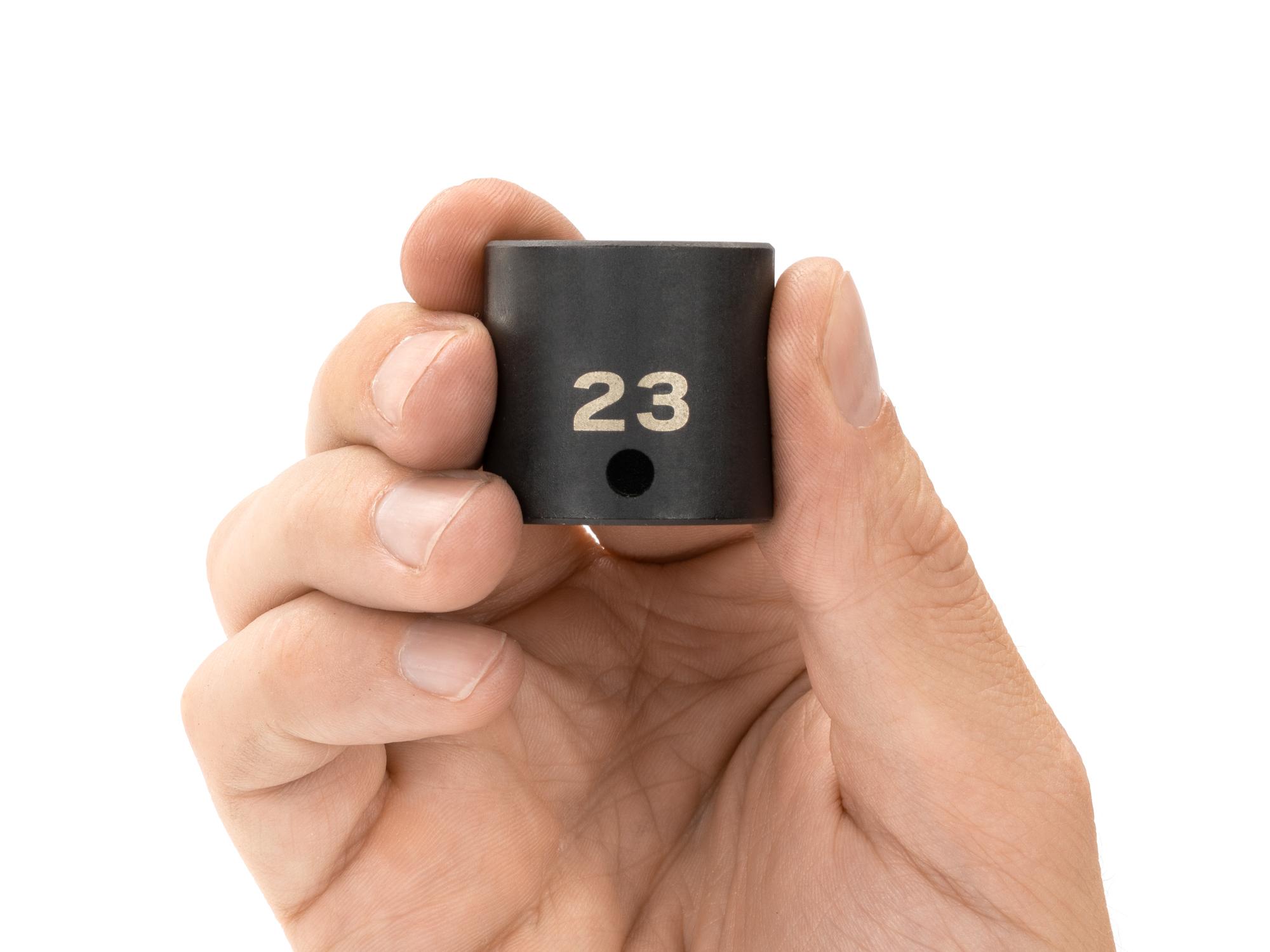 Person holding Tekton impact drive 12-point socket. Item #SID12323