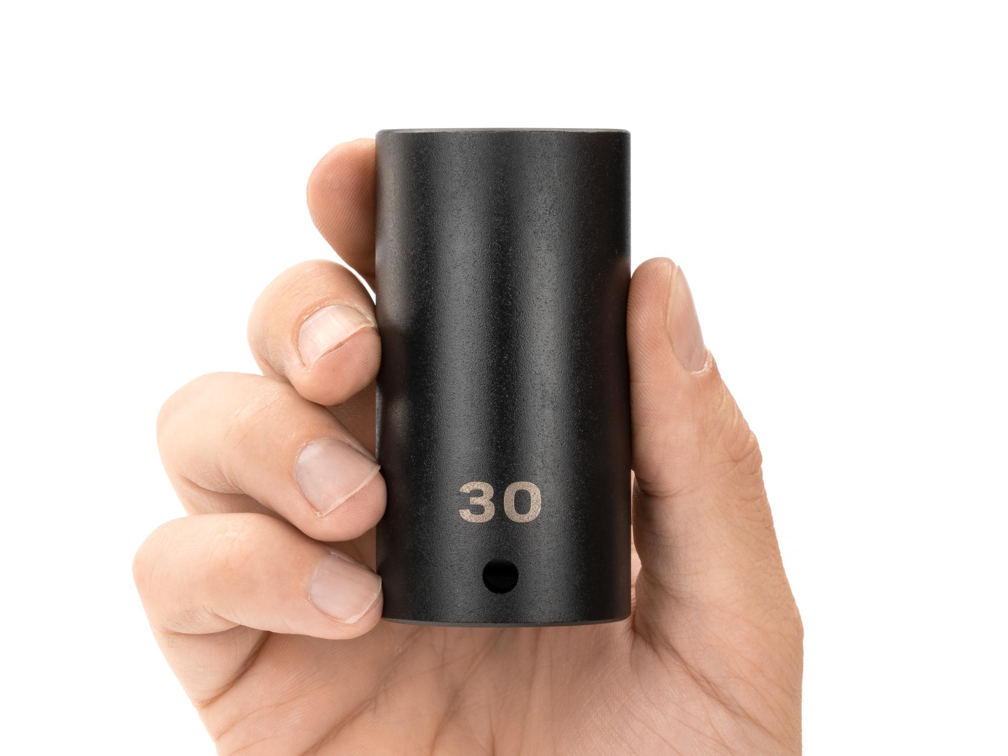 Person holding Tekton impact drive 12-point socket. Item #SID23330