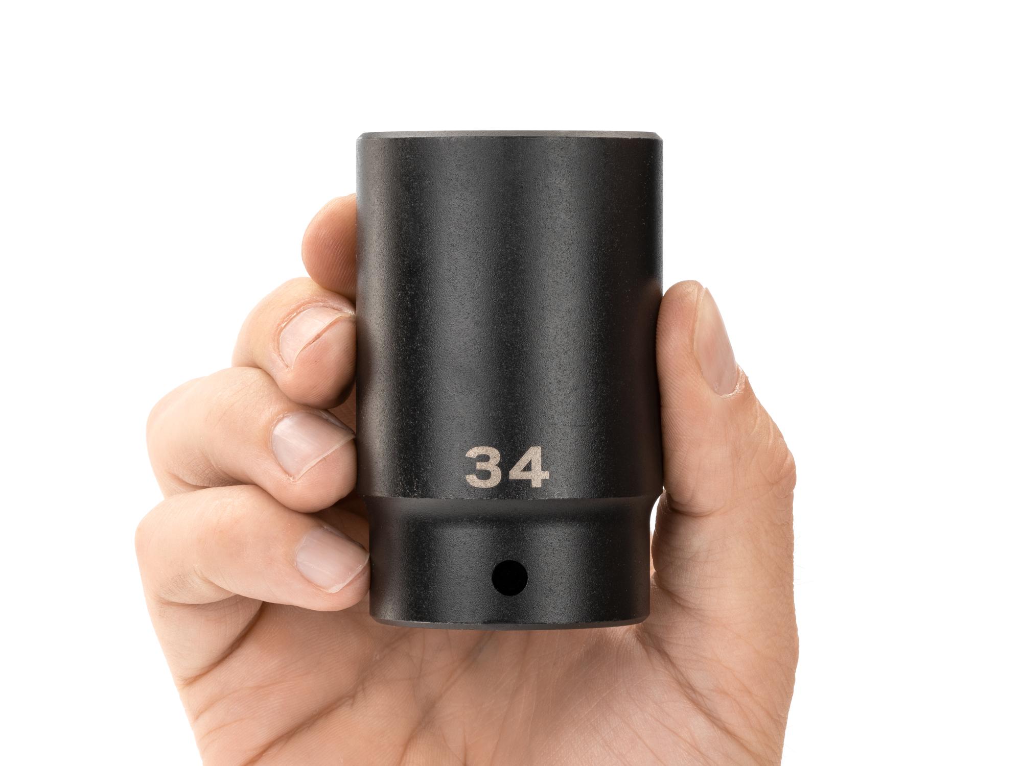 Person holding Tekton impact drive 12-point socket. Item #SID23334