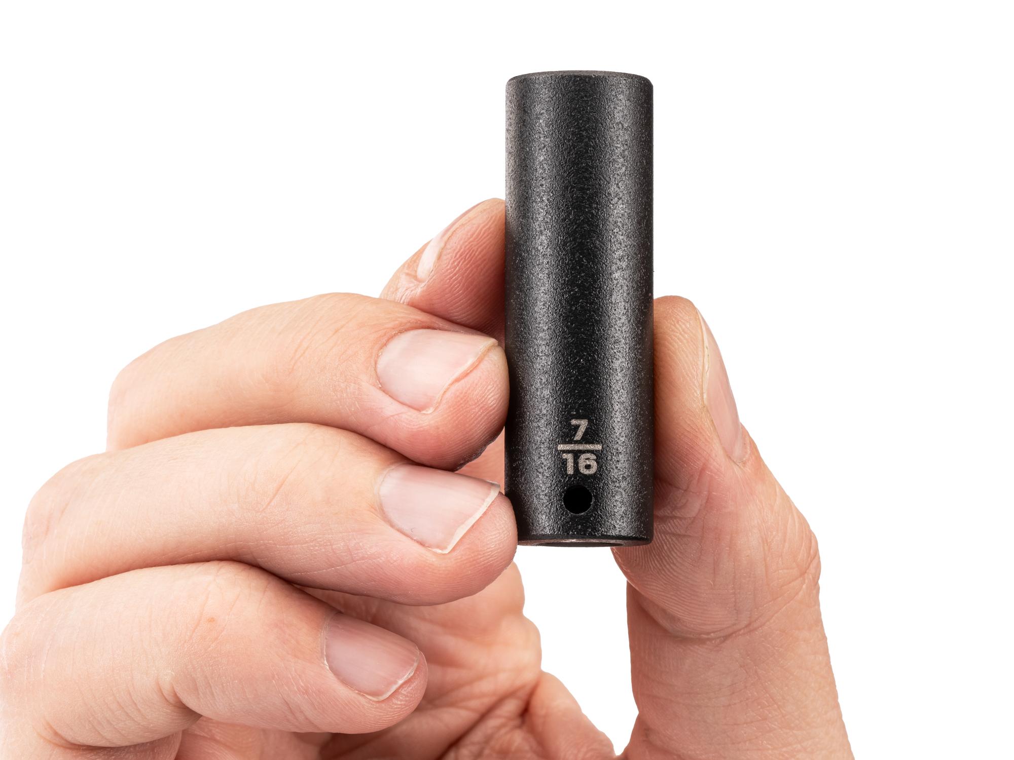Person holding Tekton impact drive 6-point socket. Item #SID03011