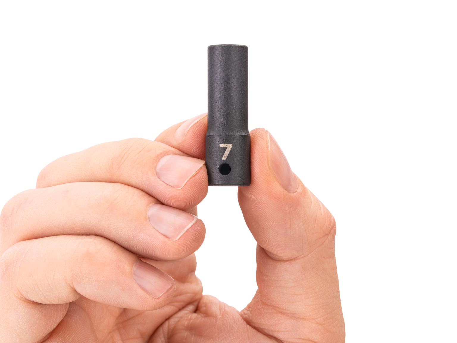 Person holding Tekton impact drive 6-point socket. Item #SID04107