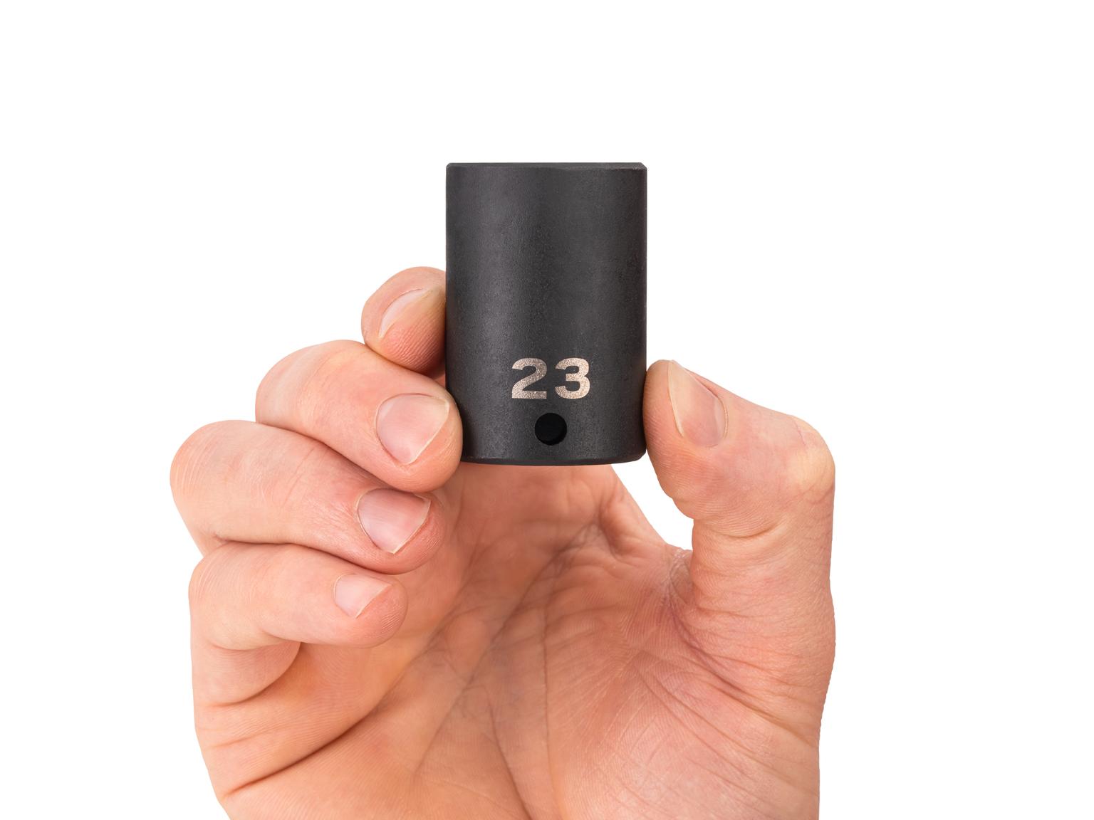 Person holding Tekton 23 millimeter impact drive 6-point socket. Item #SID14123