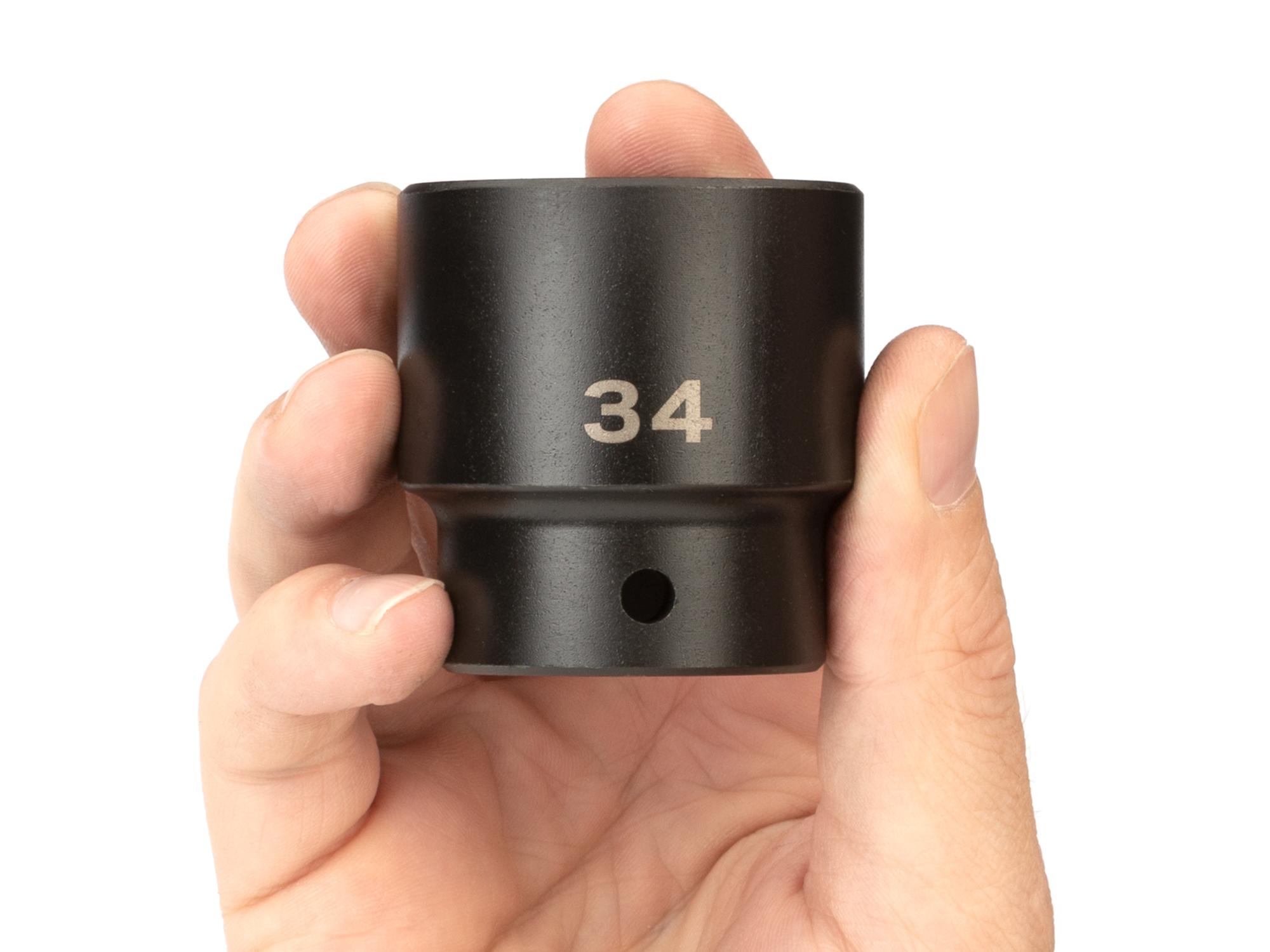 Person holding Tekton impact drive 6-point socket. Item #SID22134