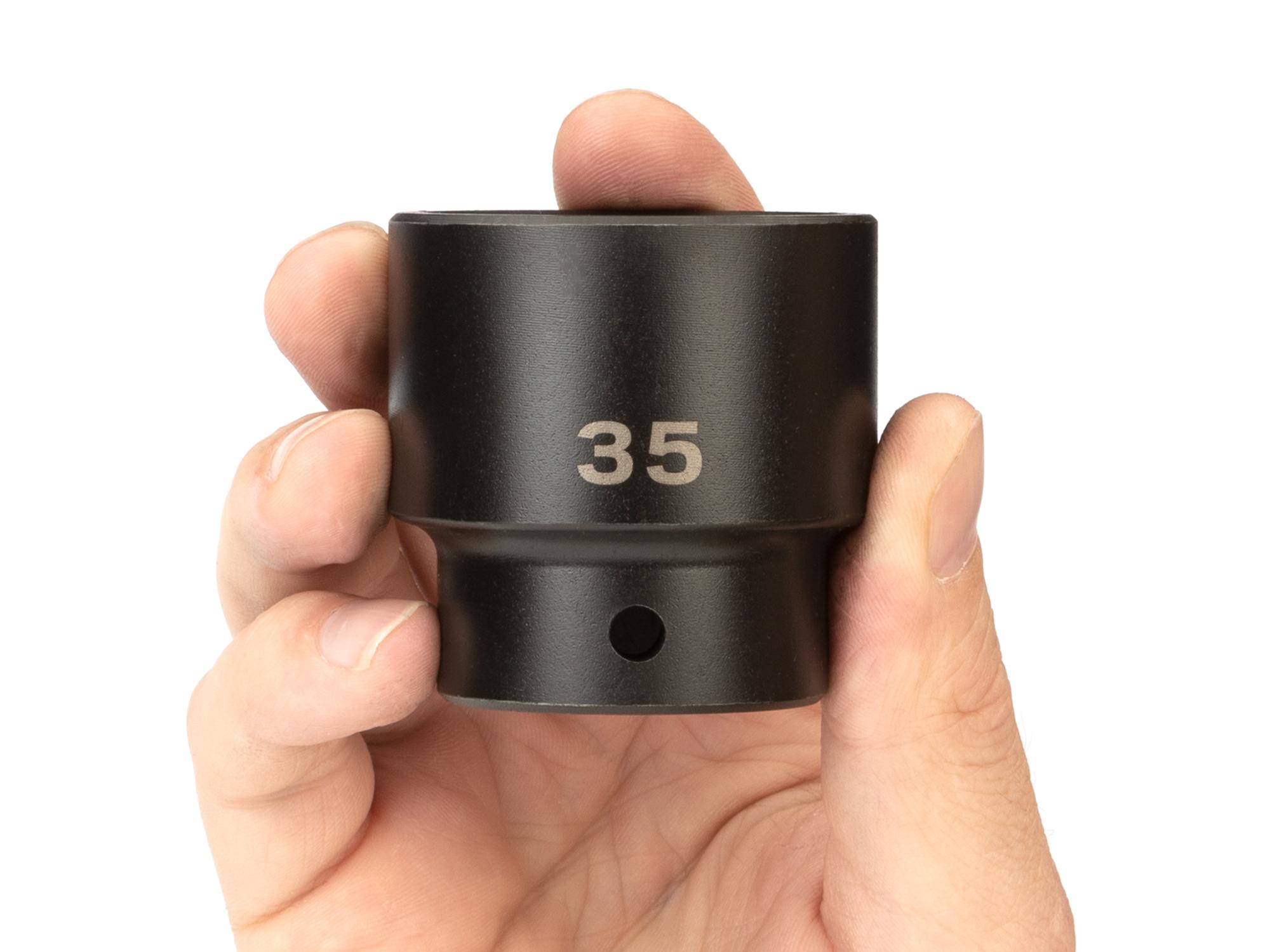 Person holding Tekton impact drive 6-point socket. Item #SID22135