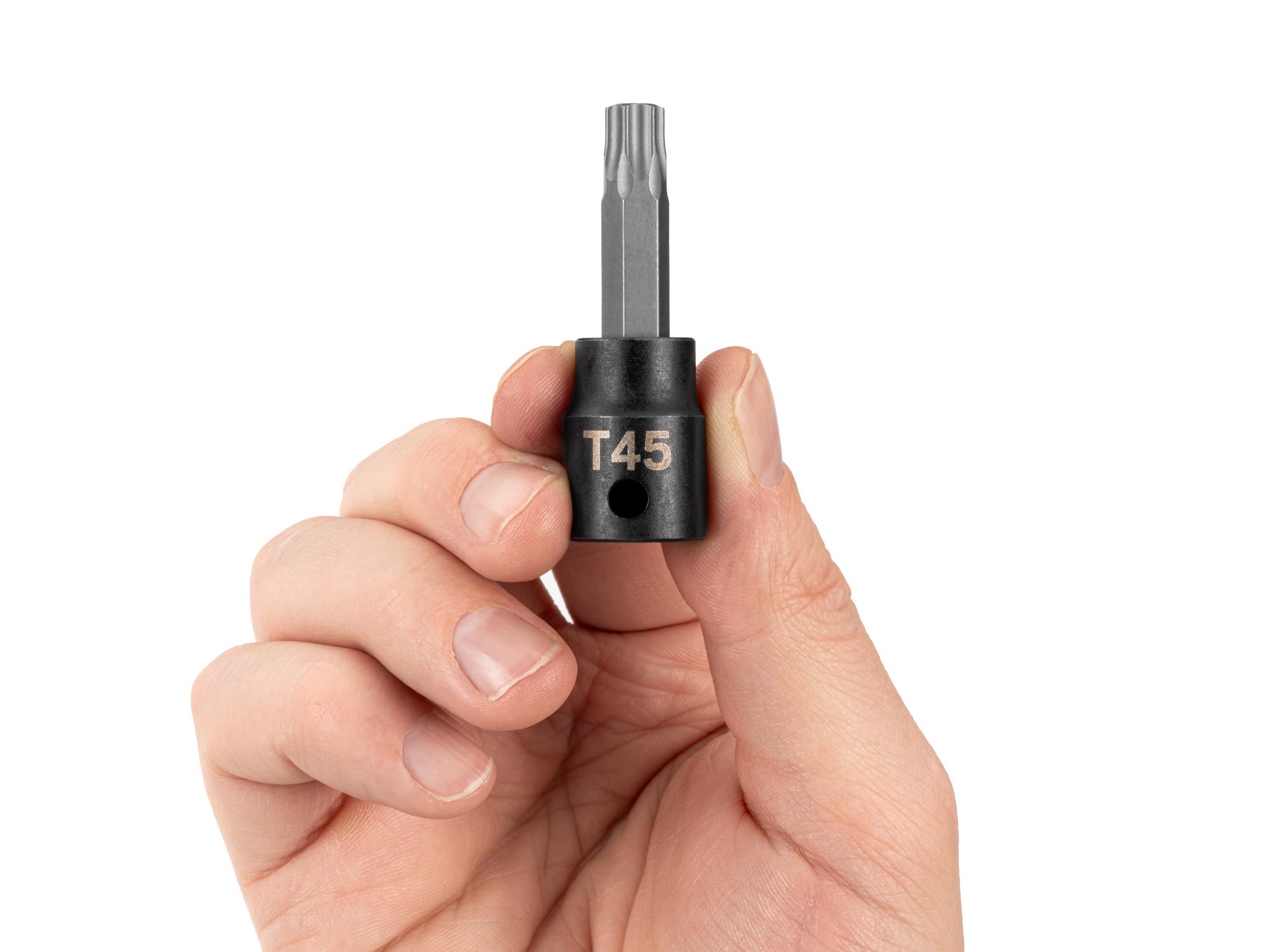 Person holding Tekton impact drive bit socket. Item #SIB14245