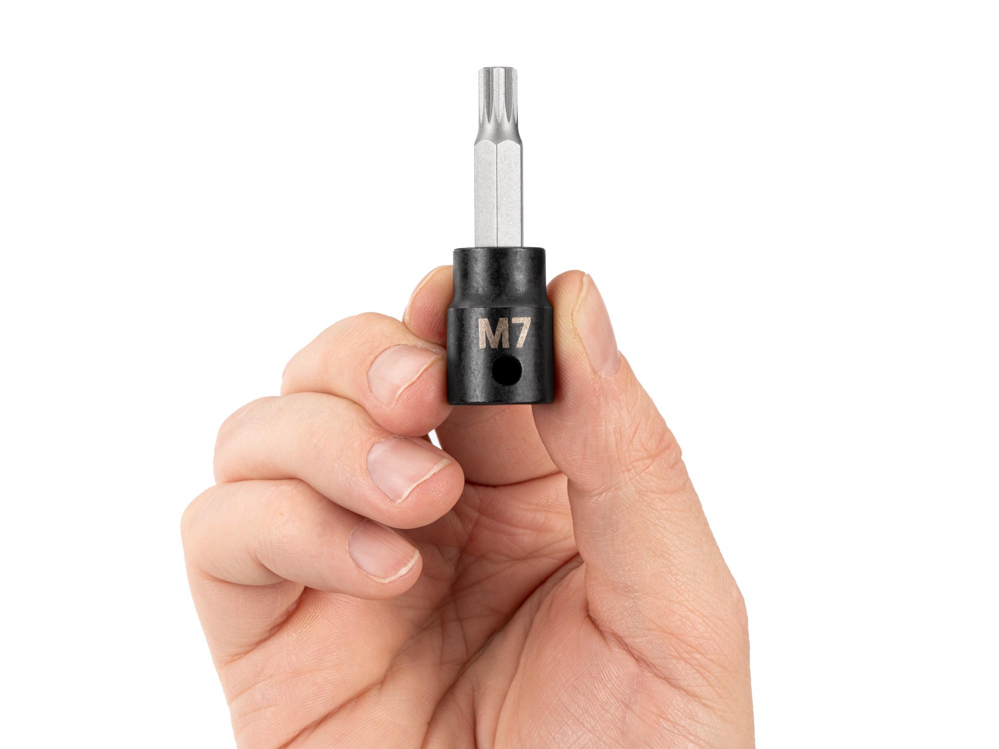 Person holding Tekton impact drive bit socket. Item #SIB18207