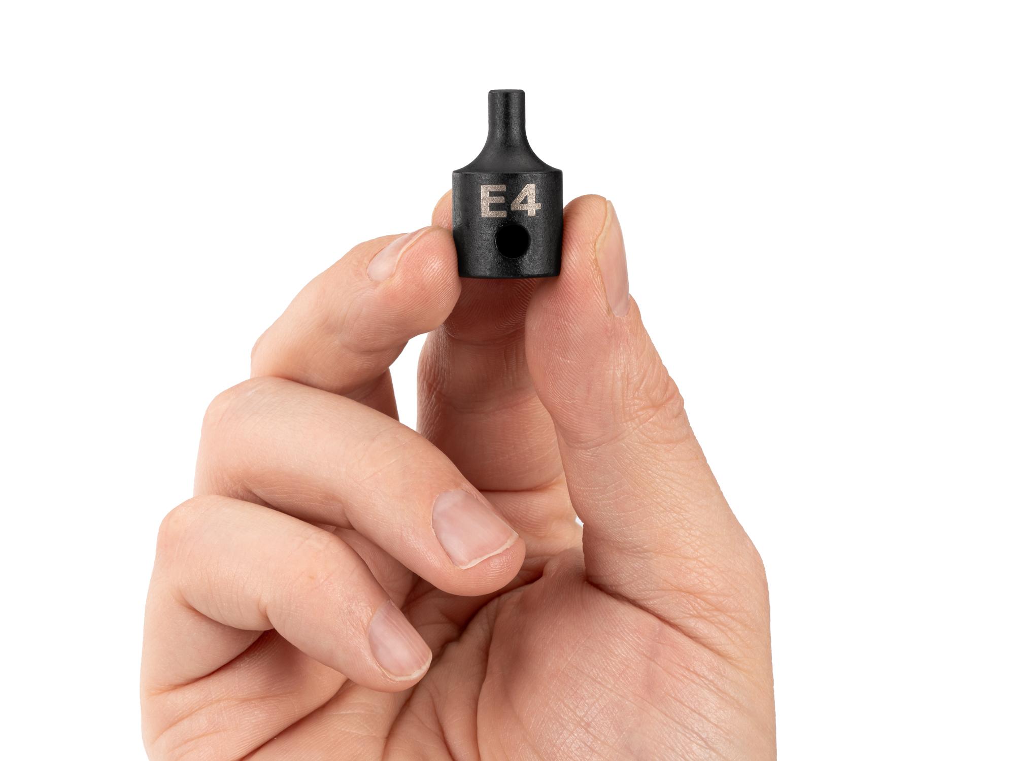 Person holding Tekton impact drive external star socket. Item #SID12404