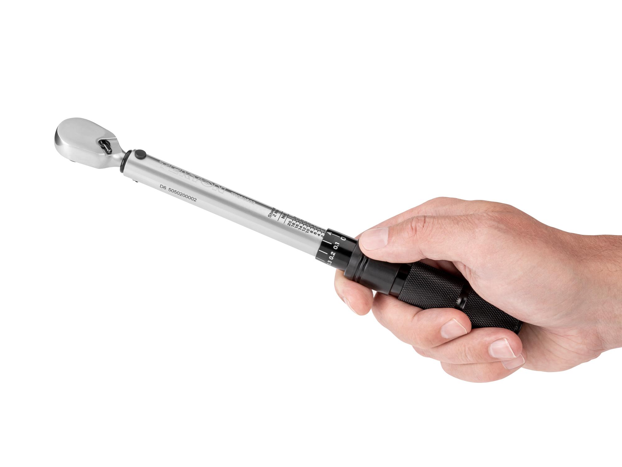Person holding Tekton case micrometer torque wrench. Item #TRQ50502
