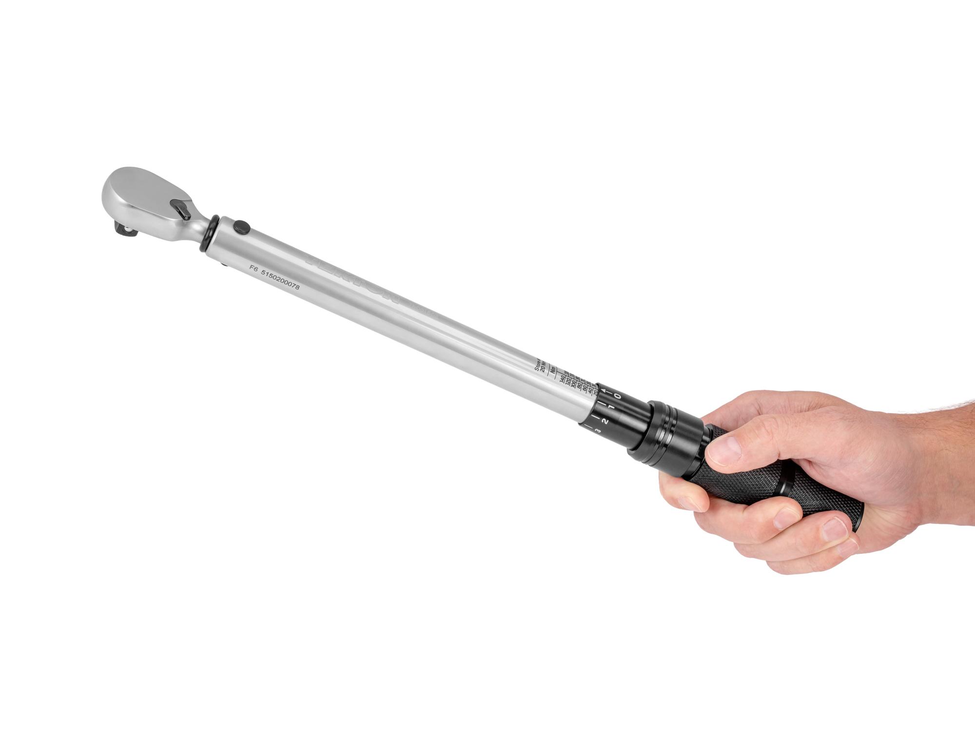 Person holding Tekton case micrometer torque wrench. Item #TRQ51502
