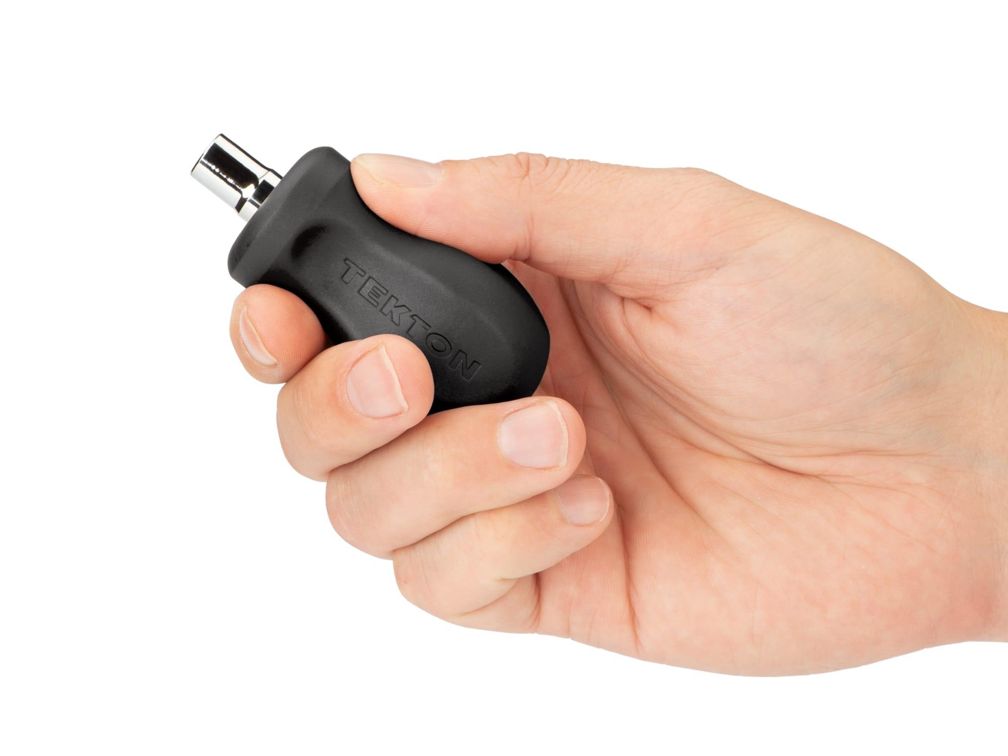 Person holding black Tekton multi-bit driver. Item #DMT13000