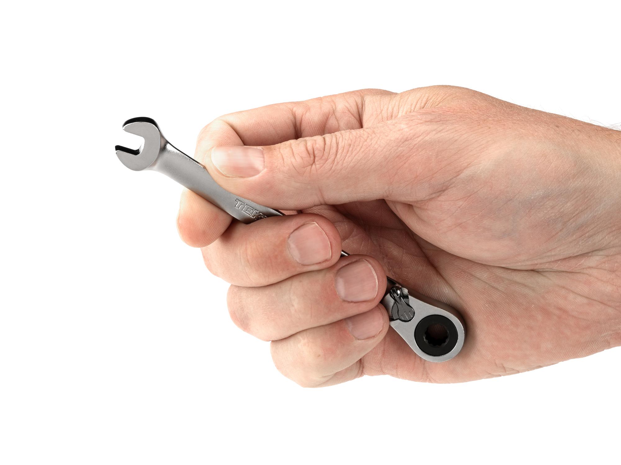 Person holding Tekton ratcheting combination wrench. Item #WRC23406