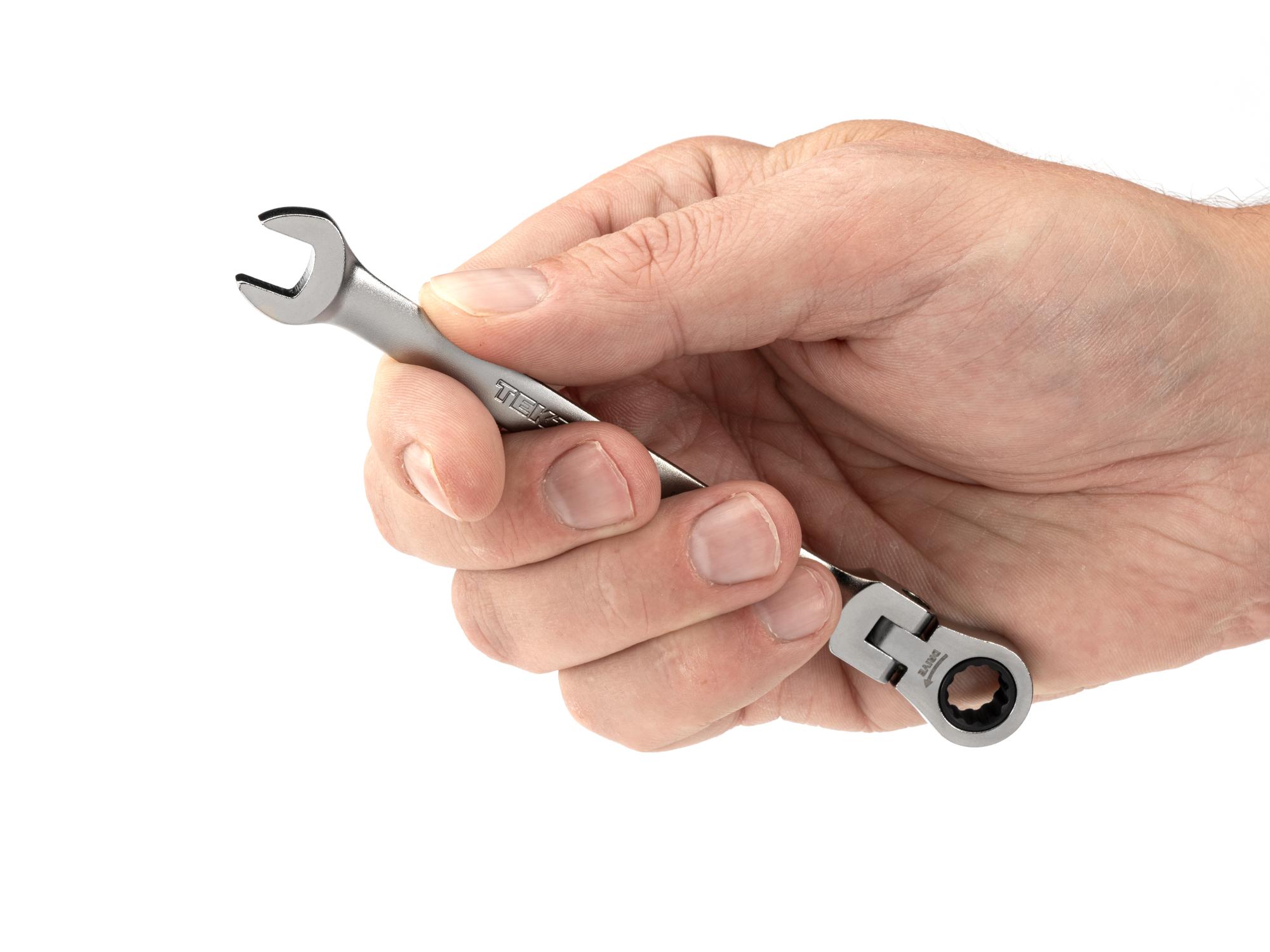 Person holding Tekton ratcheting combination wrench. Item #WRC26408