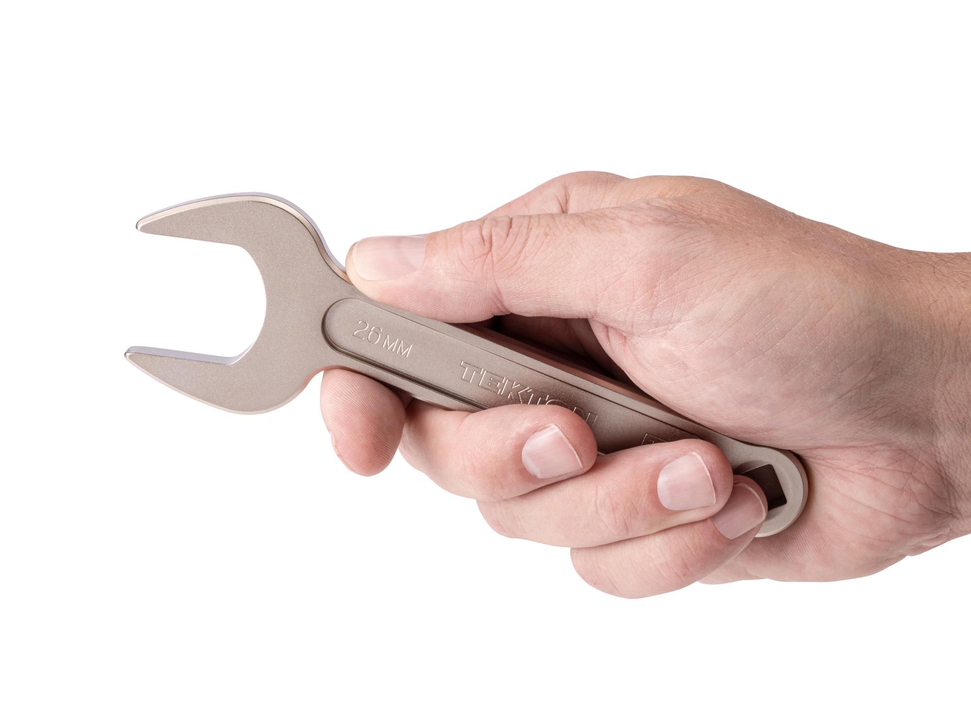 Person holding Tekton service wrench. Item #WSE14426