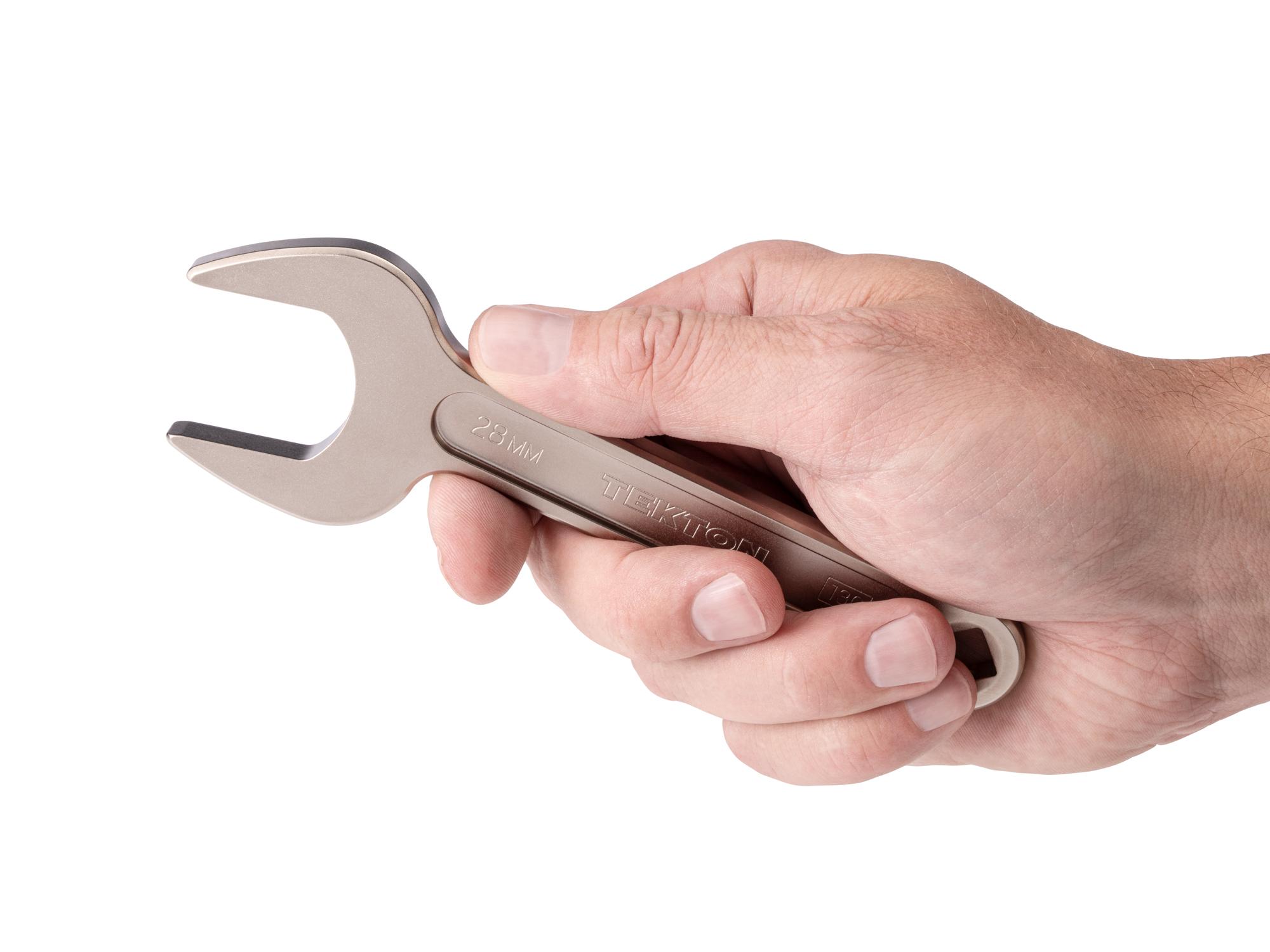 Person holding Tekton service wrench. Item #WSE14428