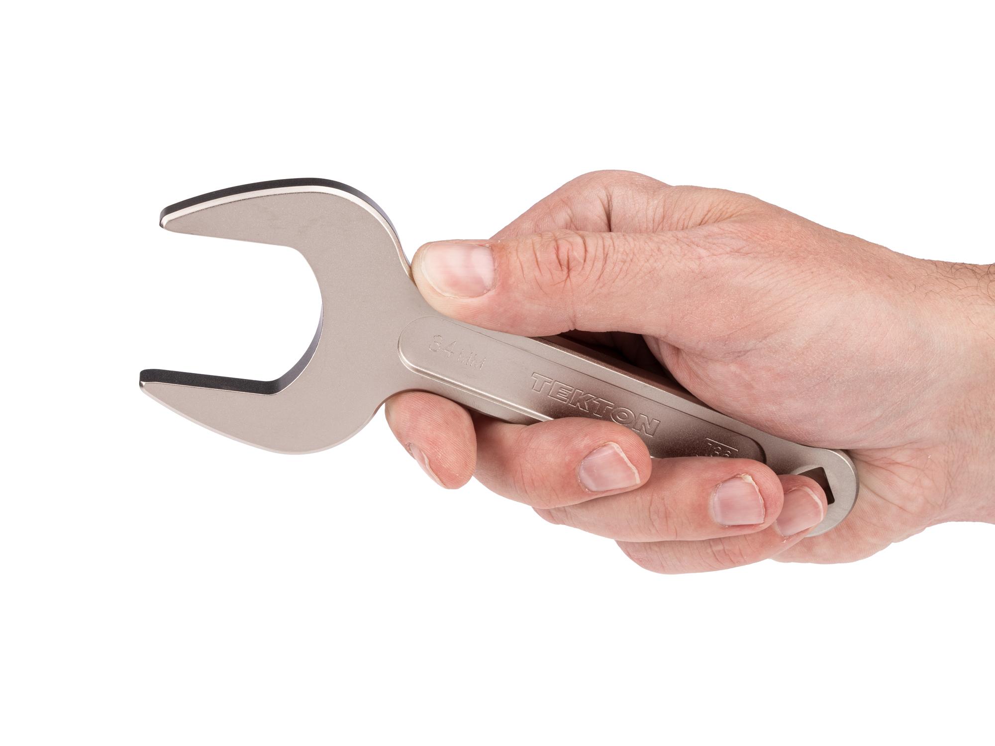 Person holding Tekton service wrench. Item #WSE14434