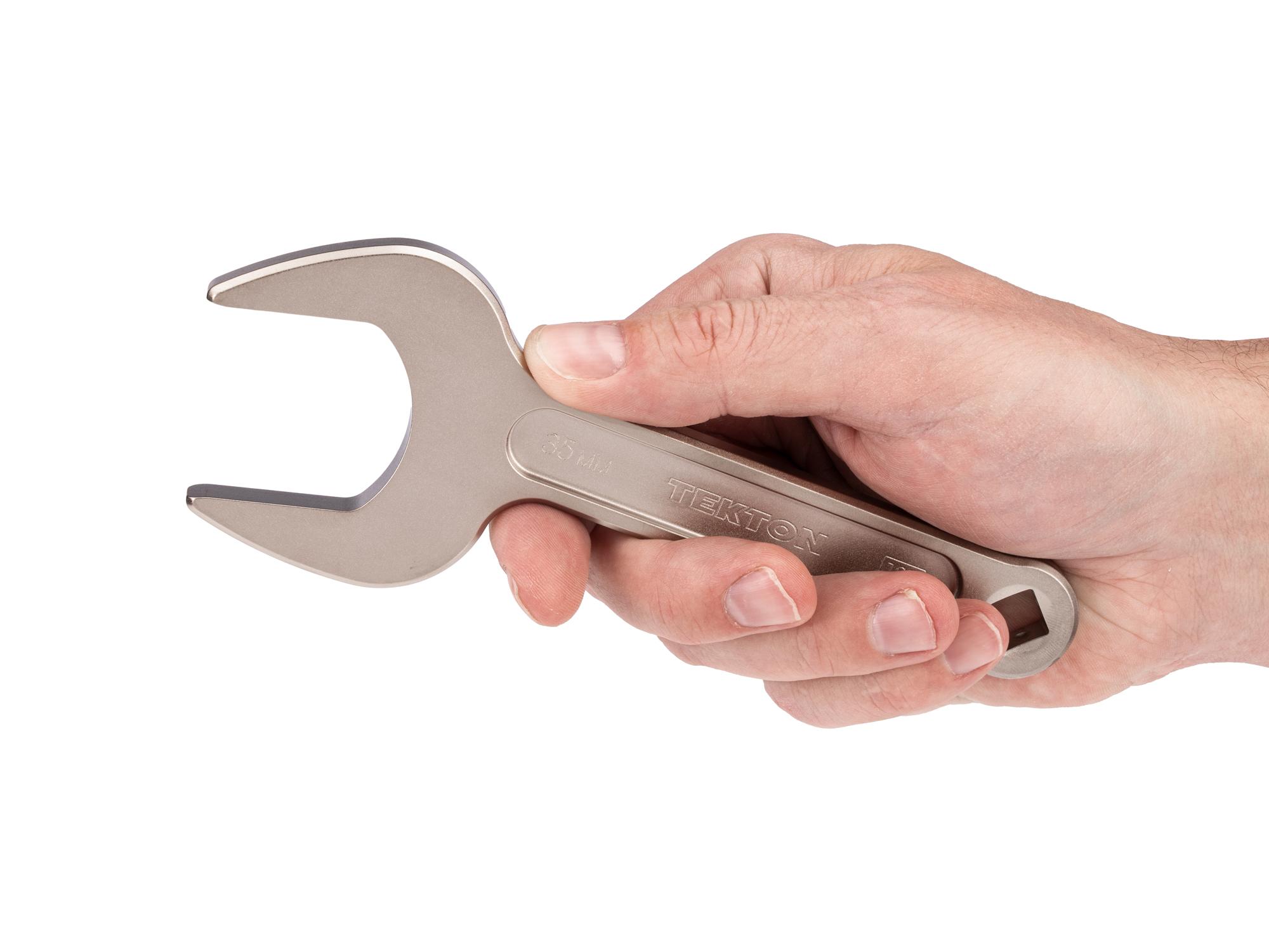 Person holding Tekton service wrench. Item #WSE14435