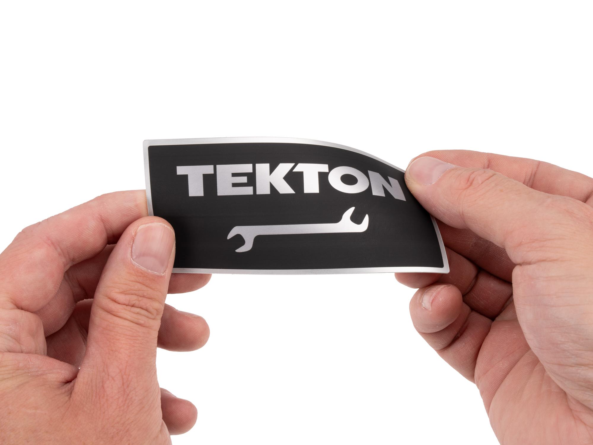 Person holding black Tekton sticker. Item #APG51009