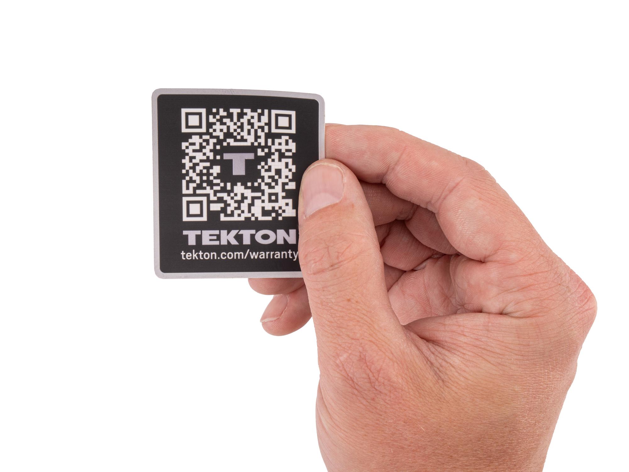 Person holding black Tekton sticker. Item #APG51010