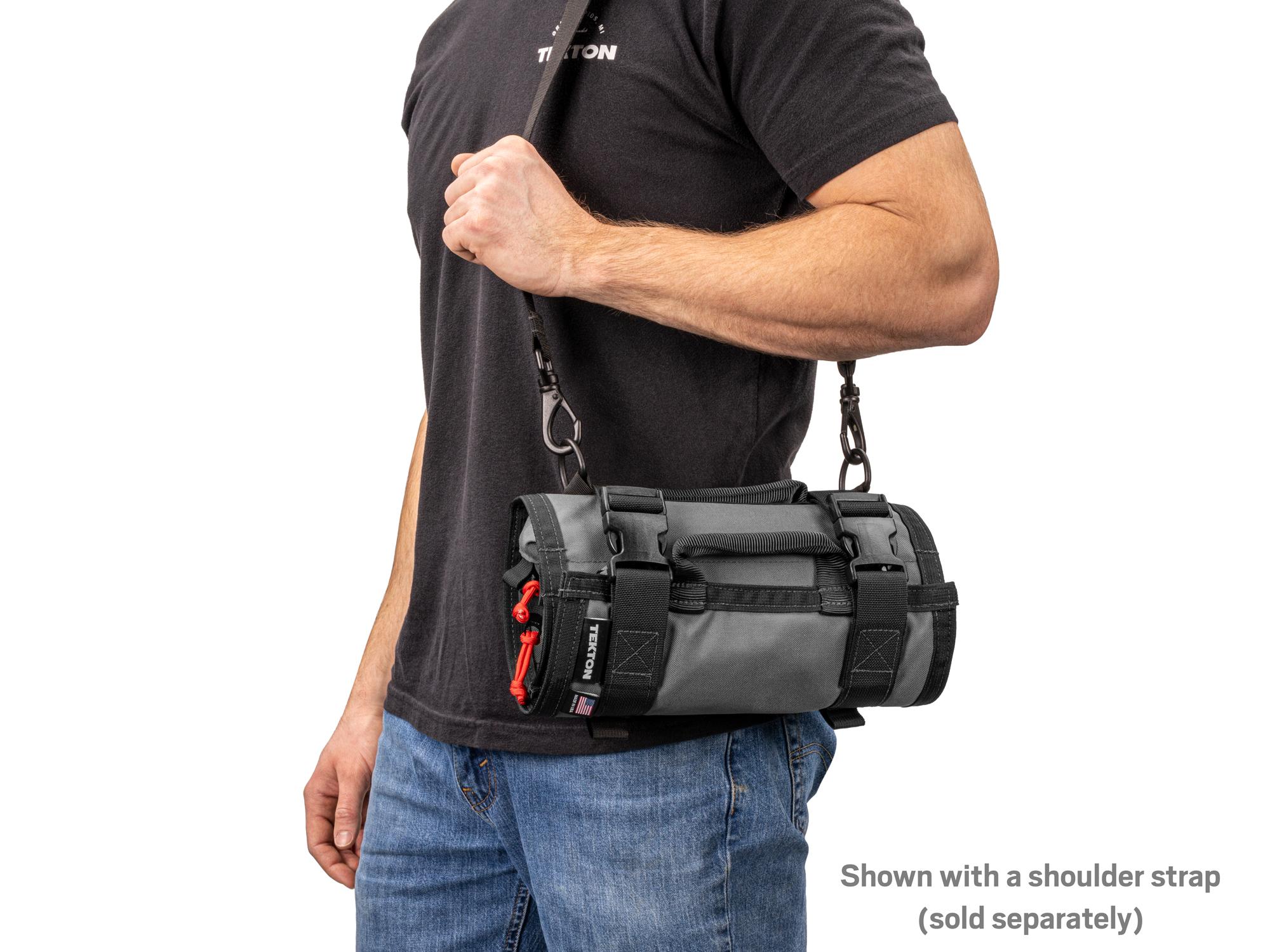 Person holding tactical-gray-red Tekton roll tool roll. Item #OTR00001