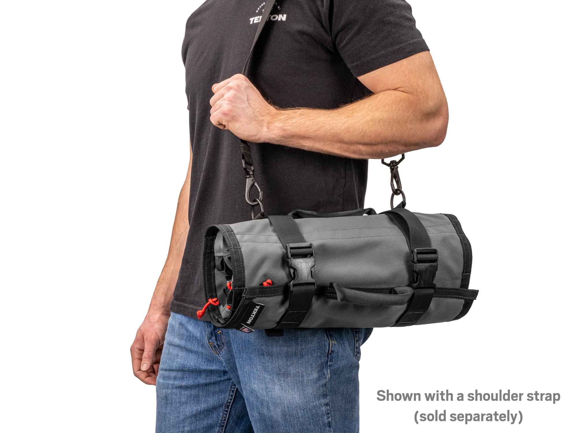 Person holding tactical-gray-red Tekton roll tool roll. Item #OTR00004