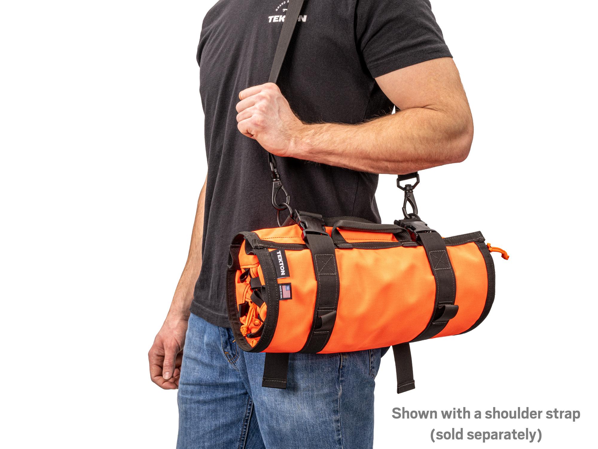 Person holding high-vis-orange Tekton roll tool roll. Item #OTR00009