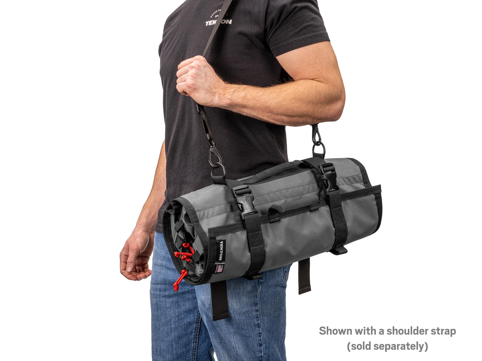Person holding tactical-gray-red Tekton roll tool roll. Item #OTR00010