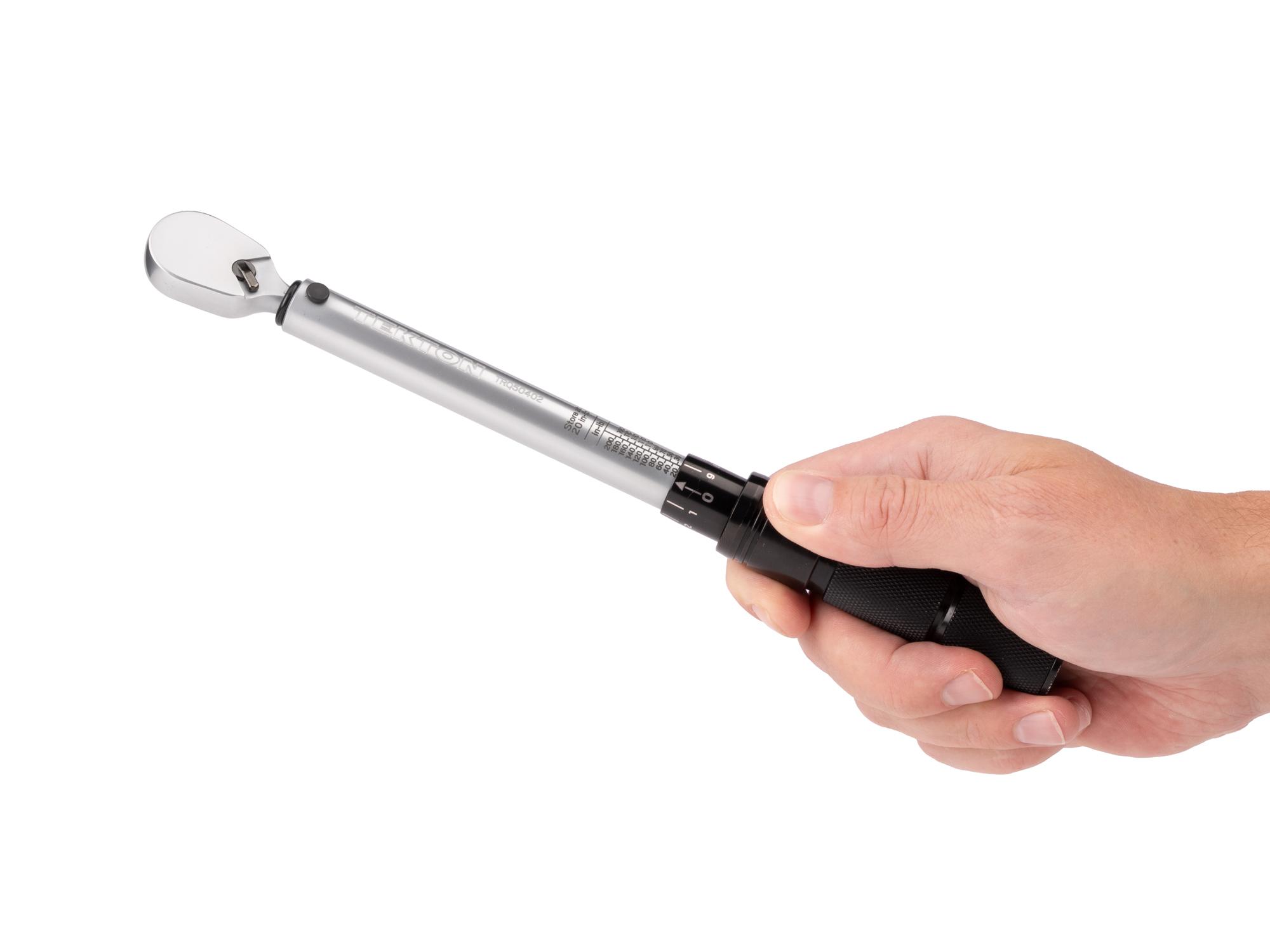 Person holding Tekton case micrometer torque wrench. Item #TRQ50402