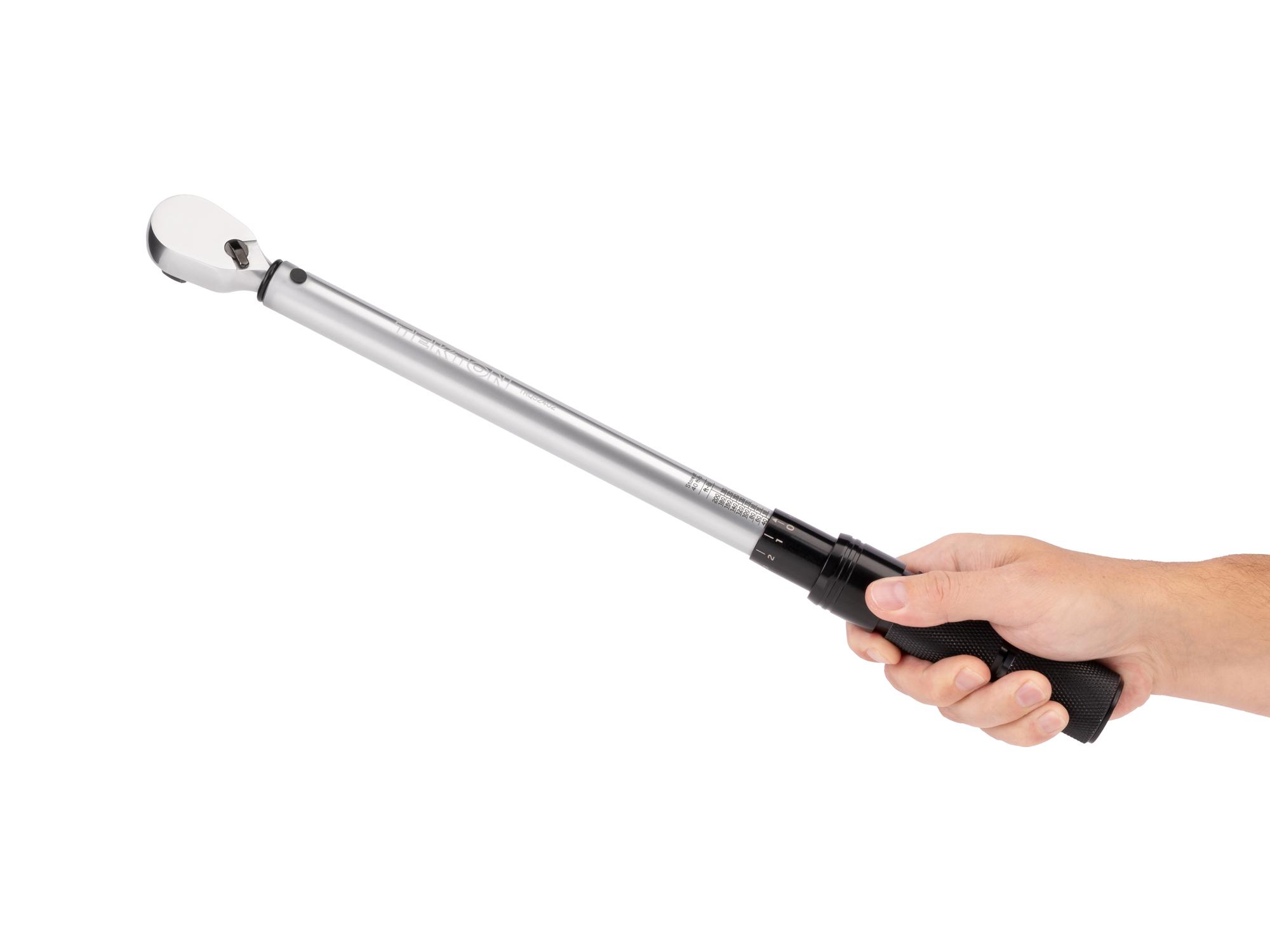 Person holding Tekton case micrometer torque wrench. Item #TRQ52402