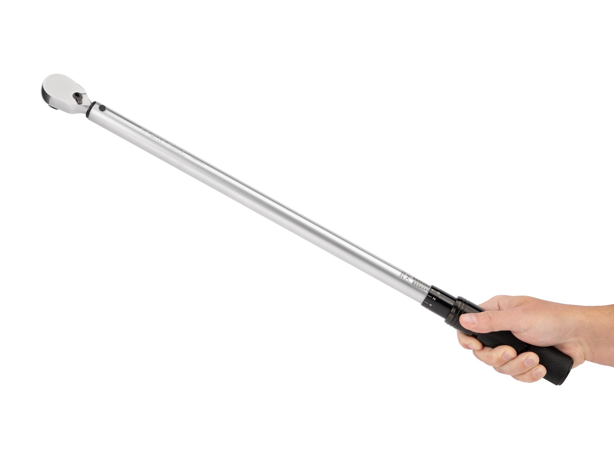 Person holding Tekton case micrometer torque wrench. Item #TRQ52403