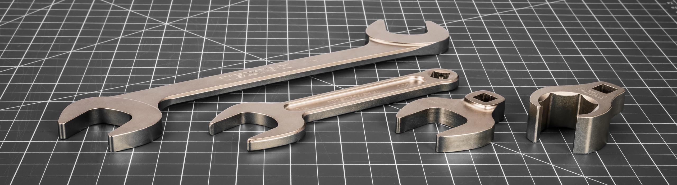 Tekton angle, service, crowfoot, and flare nut crowfoot wrenches on a gray mat.