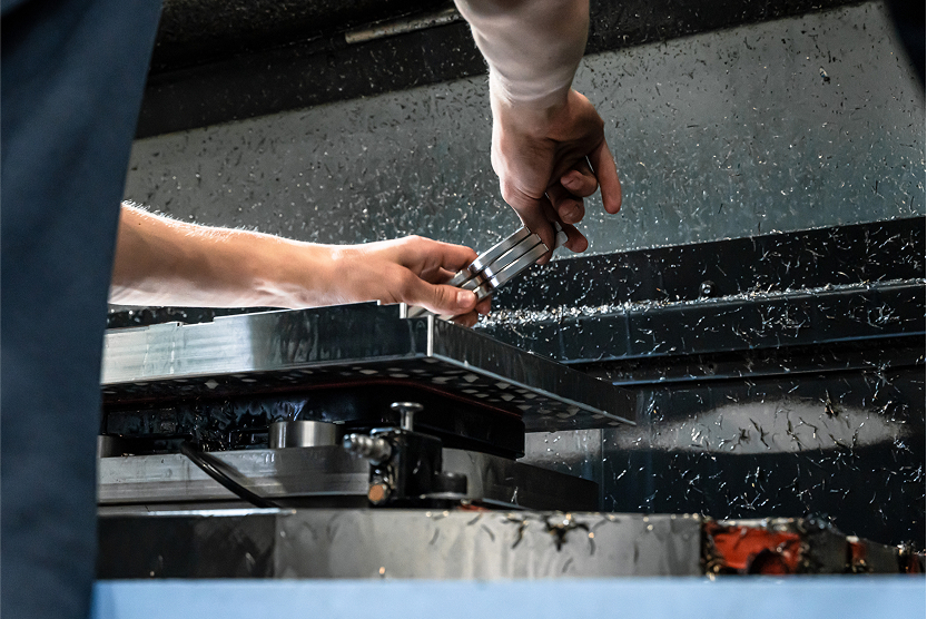 A person cutting wrenches with a CNC machine