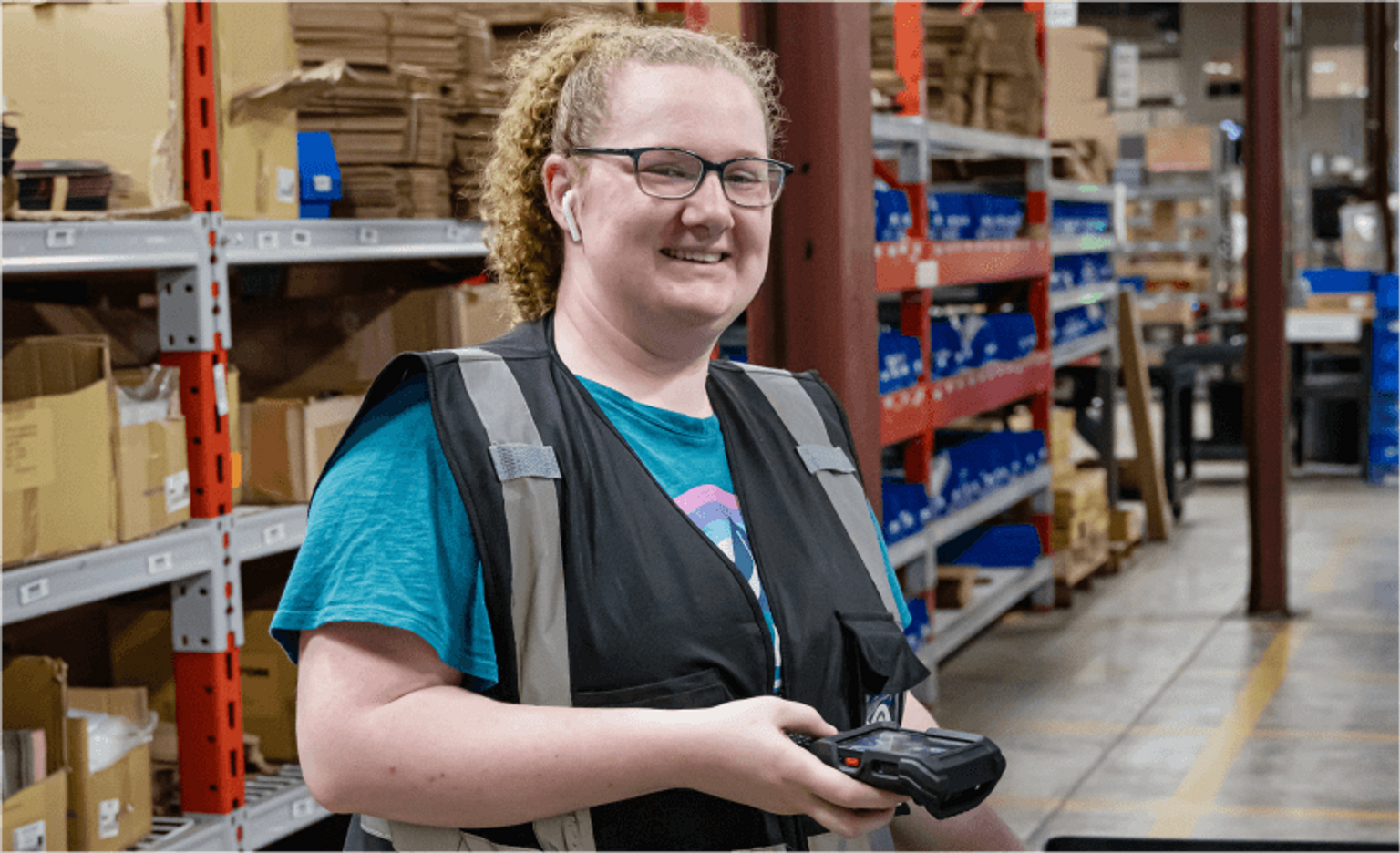 Tekton fulfillment specialist holding barcode scanner.