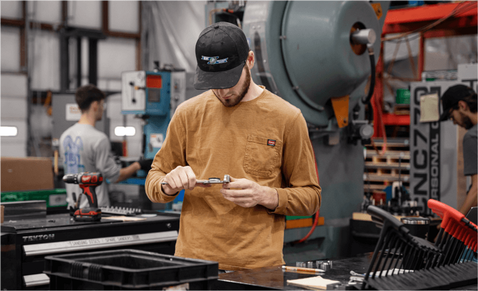 Tekton fulfillment specialist assembling a shipping box to ship hand tools.