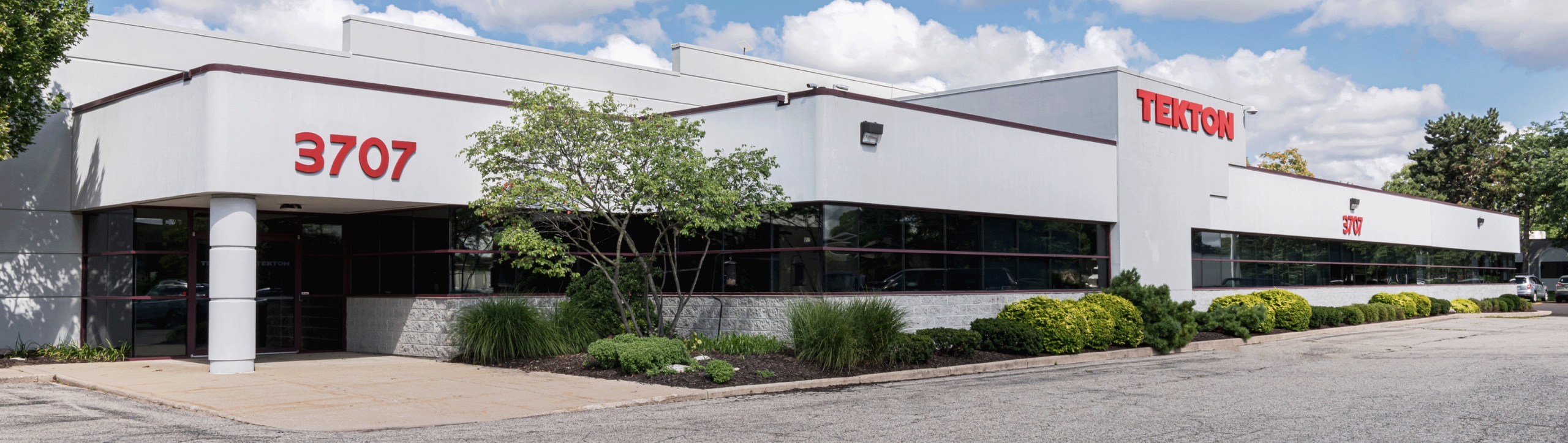 White Tekton building exterior on a sunny day. 