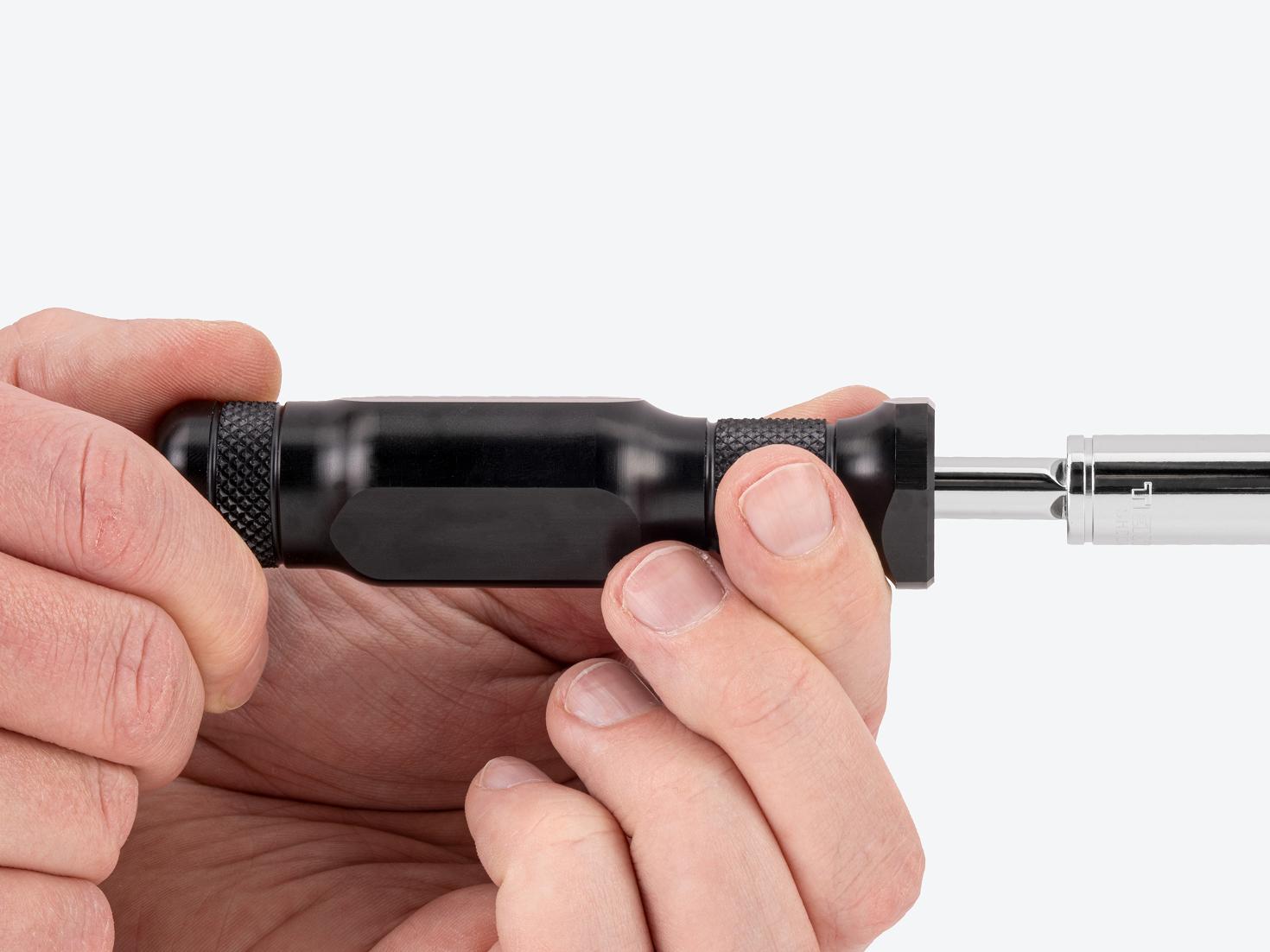 Two hands spinning a spinner handle with socket