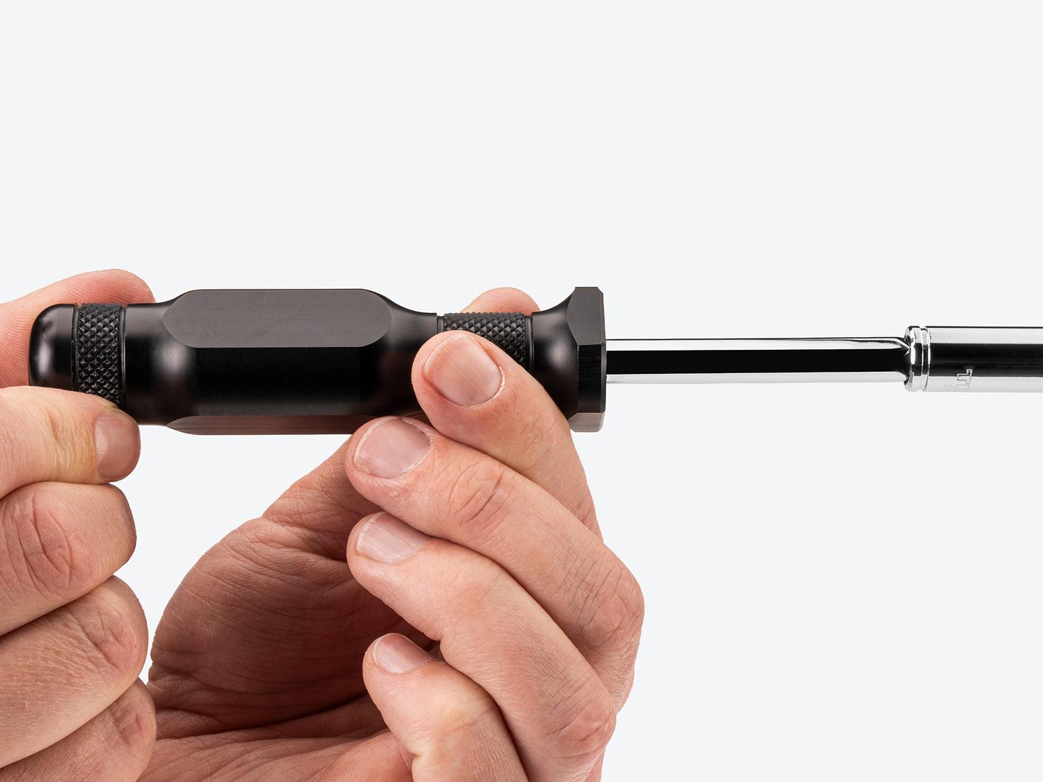 Two hands spinning a spinner handle with socket