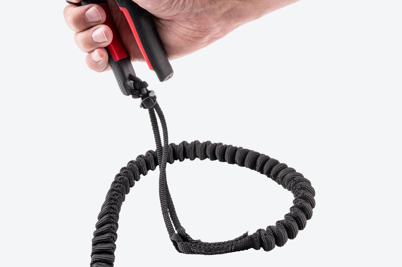 A tether secured onto the handle of the snips