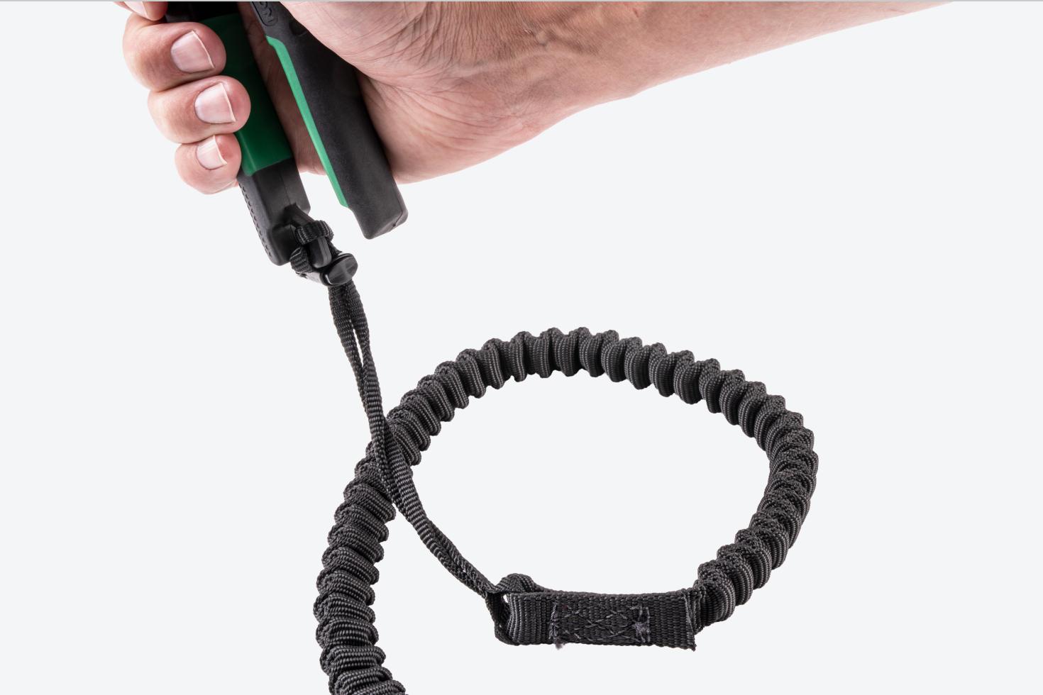A tether secured onto the handle of the snips