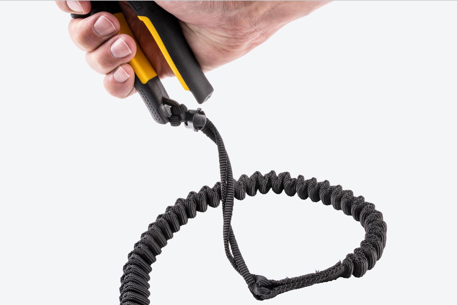 A tether secured onto the handle of the snips