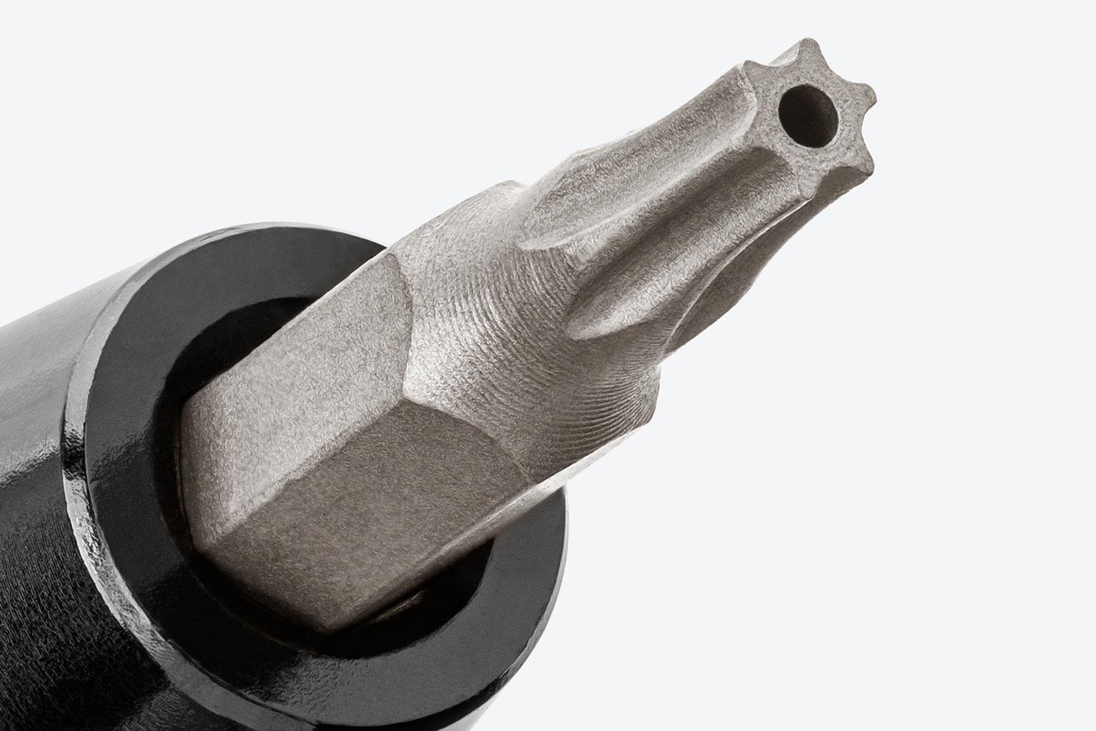 The tip of a tamper star 4 mm bit in a bit driver.