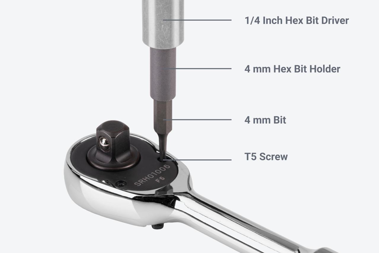 A 1/4 inch bit driver with a 4 mm bit holder driving a T5 screw on a ratchet face plate