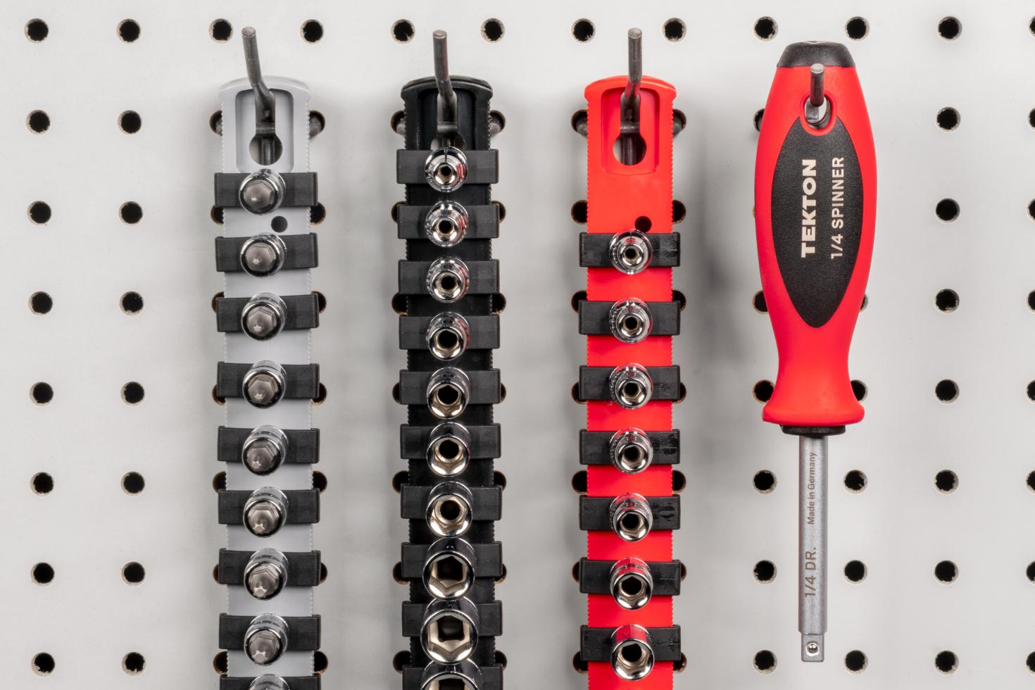 A spinner handle and socket rails hanging on a pegboard