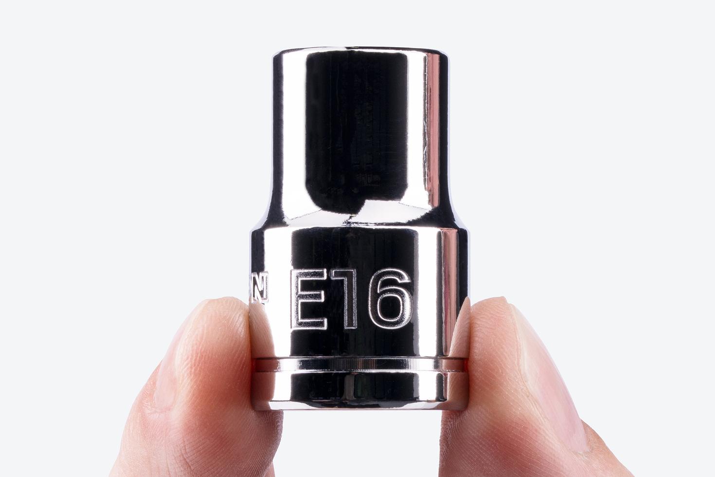 A Tekton 1/2 Inch Drive x E16 External Star Socket being held, showing the large stamped "E16" markings.