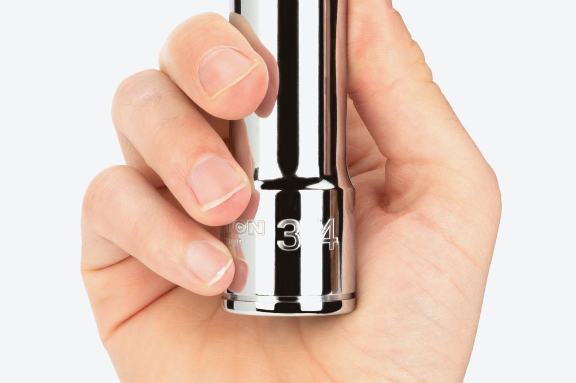 A hand holding a 3/4 inch deep socket