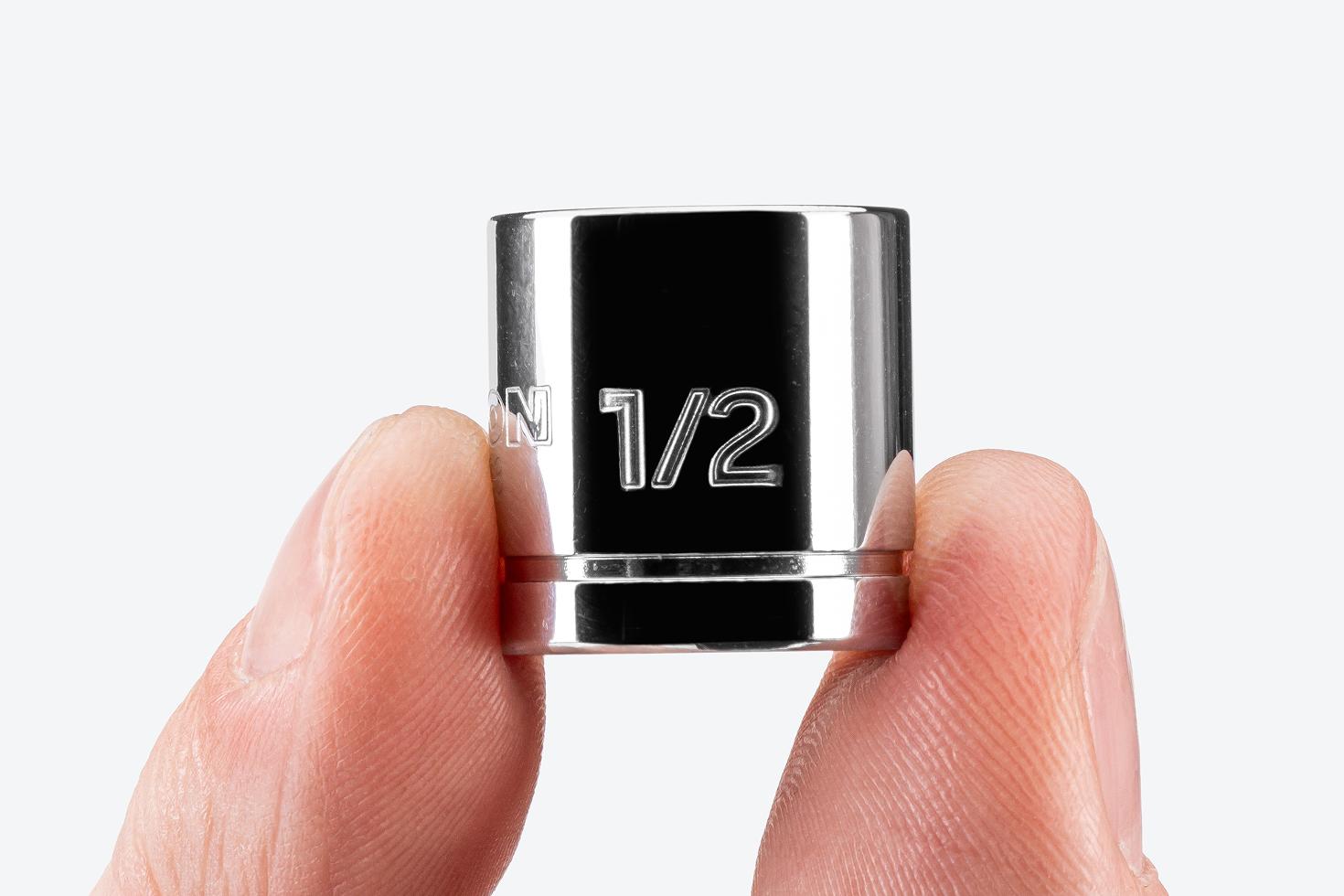 A hand holding a 1/2 inch extra-shallow socket