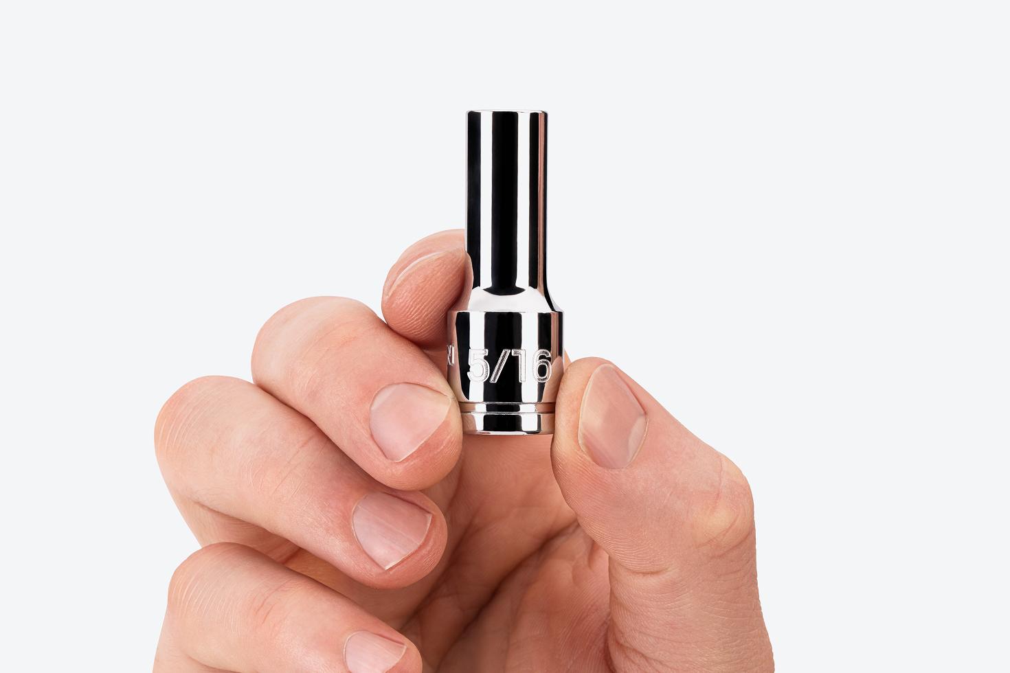 A hand holding a 5/16 inch semi-deep socket